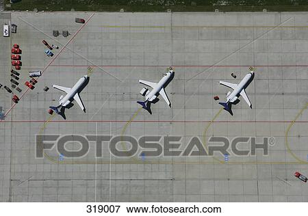 Stock Photo - Aerial view of a row of airplanes parked. Fotosearch
