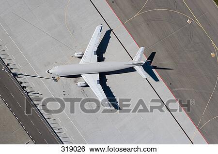 Aerial view of airplane on tarmac View Large Photo Image Stock Photograph - Aerial view of airplane on tarmac. Fotosearch