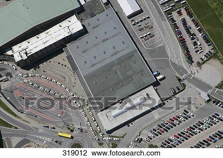 Stock Image - Aerial view of airport roof and parking lot. Fotosearch