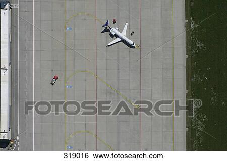 Stock Photograph - Aerial view of parked plane on airport tarmac. Fotosearch