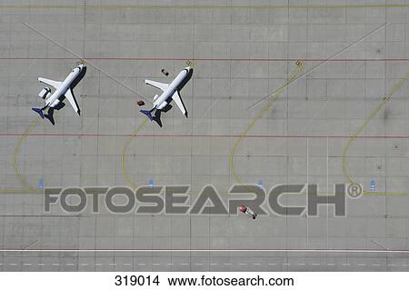 Picture - Aerial view of two airplanes parked in a row. Fotosearch