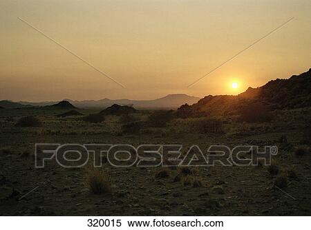 Sunset over arid landscape, Etosha National Park, Namibia View Large Photo Image Stock Photography - Sunset over arid landscape, Etosha National Park, Namibia. Fotosearch