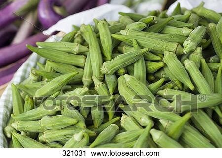 Stock Image - Basket of okra at market stall. Fotosearch