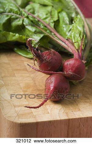 Bunch of beetroot on wooden cutting board View Large Photo Image Stock Image - Bunch of beetroot on wooden cutting board. Fotosearch