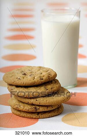 Glass of milk and pile of cookies on table View Large Photo Image Stock Image - Glass of milk and pile of cookies on table. Fotosearch