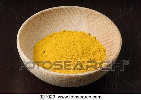 Yellow spice in a wooden bowl View Large Photo Image Stock Photo - Yellow spice in a wooden bowl. Fotosearch