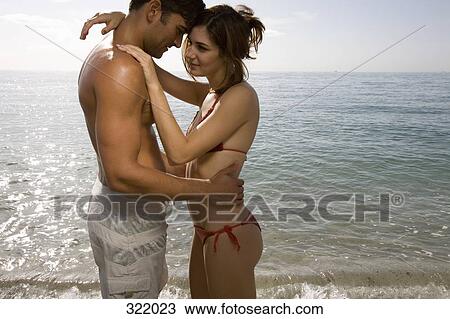 Couple embracing in front of sea View Large Photo Image Stock Image - Couple embracing in front of sea. Fotosearch