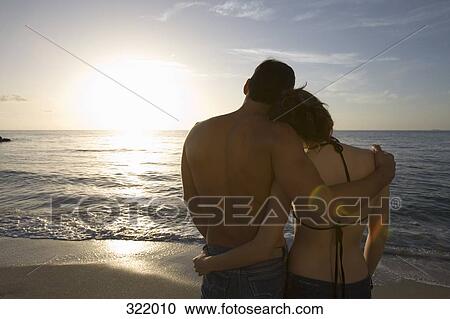 Couple looking at view of sea View Large Photo Image Stock Image - Couple looking at view of sea. Fotosearch