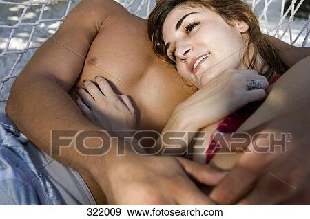 Man and woman embracing on hammock View Large Photo Image Stock Photo - Man and woman embracing on hammock. Fotosearch