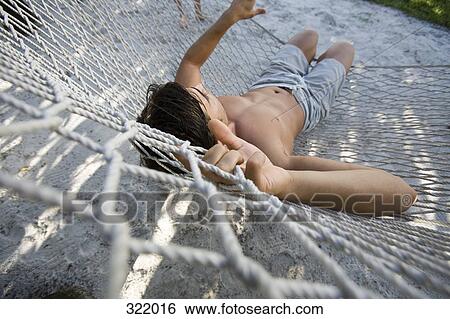 Man relaxing in hammock View Large Photo Image Stock Photograph - Man relaxing in hammock. Fotosearch