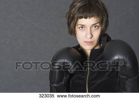 Female boxer wearing black sweater and boxing gloves View Large Photo Image Stock Photography - Female boxer wearing black sweater and boxing gloves. Fotosearch