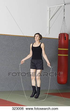 Woman jumping rope in gym View Large Photo Image Stock Photograph - Woman jumping rope in gym. Fotosearch