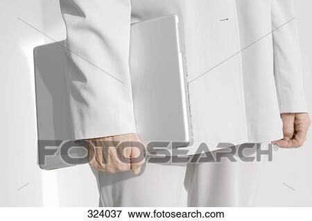 Stock Photo - Businesswoman holding a laptop computer. Fotosearch
