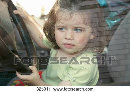 Young girl sitting in driver’s seat of car View Large Photo Image Stock Image - Young girl sitting in driver’s seat of car. Fotosearch