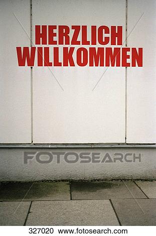 Stock Image - ‘Herzlich Willkommen’ sign on building exterior. Fotosearch