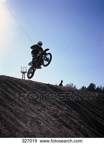 Motocross rider in mid-air View Large Photo Image Stock Photo - Motocross rider in mid-air. Fotosearch