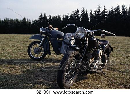 Two motorcycles parked on grass near woods View Large Photo Image Stock Image - Two motorcycles parked on grass near woods. Fotosearch