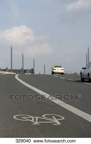 Bicycle lane next to two lane highway View Large Photo Image Stock Image - Bicycle lane next to two lane highway. Fotosearch