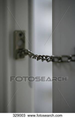 Close-up of chain across open door View Large Photo Image Stock Image - Close-up of chain across open door. Fotosearch