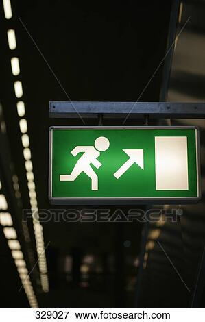 Illuminated emergency exit sign View Large Photo Image Stock Photo - Illuminated emergency exit sign. Fotosearch