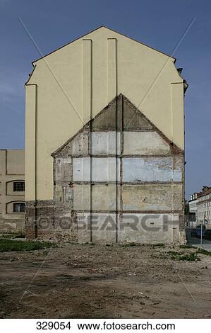 Vacant block next to outline of old house on apartment building View Large Photo Image Picture - Vacant block next to outline of old house on apartment building. Fotosearch