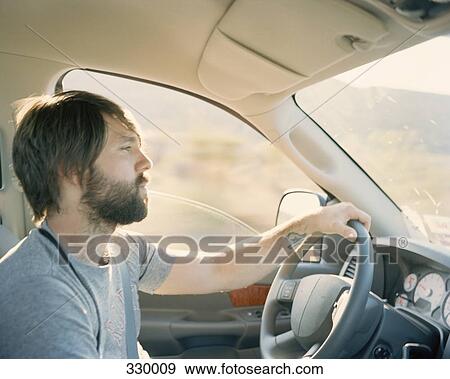 Man driving car View Large Photo Image Stock Photo - Man driving car. Fotosearch