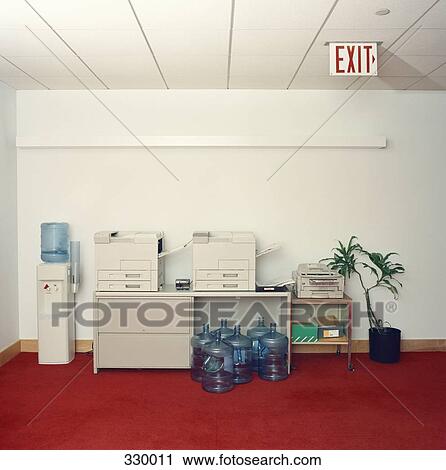 Photocopy machines next to water cooler in office View Large Photo Image Stock Image - Photocopy machines next to water cooler in office. Fotosearch