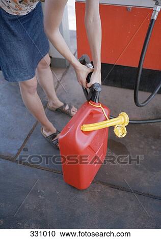 Woman filling gas can at gas station, View Large Photo Image Stock Image - Woman filling gas can at gas station,. Fotosearch