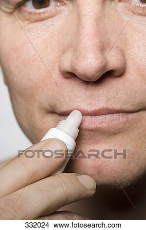 Man applying lip balm View Large Photo Image Picture - Man applying lip balm. Fotosearch