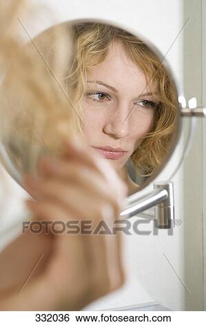 Mirror reflection of woman looking sad View Large Photo Image Stock Photograph - Mirror reflection of woman looking sad. Fotosearch