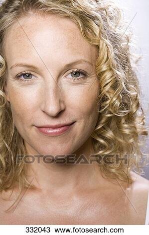 Portrait of mid-adult woman smiling View Large Photo Image Stock Image - Portrait of mid-adult woman smiling. Fotosearch