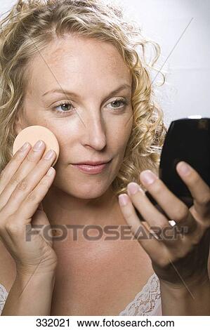 Woman applying face powder View Large Photo Image Stock Image - Woman applying face powder. Fotosearch