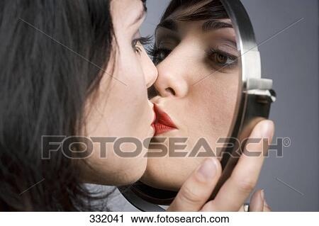 Woman kissing her reflection in mirror View Large Photo Image Stock Image - Woman kissing her reflection in mirror. Fotosearch