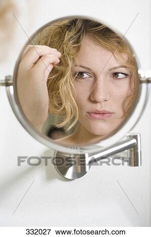Woman looking anxious in the mirror View Large Photo Image Stock Photo - Woman looking anxious in the mirror. Fotosearch