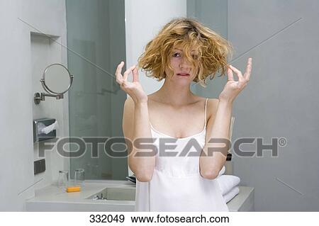 Woman looking worried in bathroom View Large Photo Image Stock Photo - Woman looking worried in bathroom. Fotosearch
