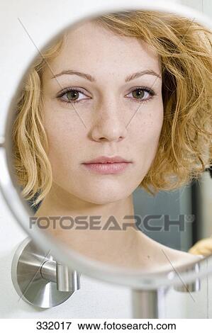 Woman looking worried in mirror View Large Photo Image Stock Photo - Woman looking worried in mirror. Fotosearch