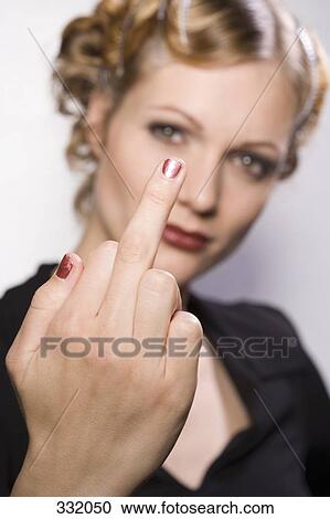 Young woman making obscene hand gesture View Large Photo Image Stock Image - Young woman making obscene hand gesture. Fotosearch