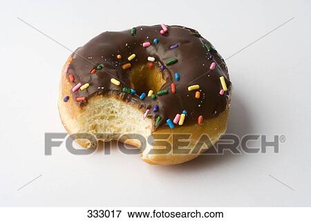 Chocolate ring donut with missing bite View Large Photo Image Stock Photo - Chocolate ring donut with missing bite. Fotosearch