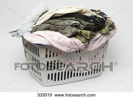 Laundry basket full of clothes View Large Photo Image Stock Photo - Laundry basket full of clothes. Fotosearch