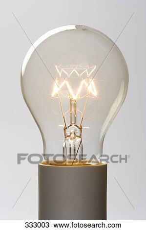 Light bulb filament glowing View Large Photo Image Stock Image - Light bulb filament glowing. Fotosearch
