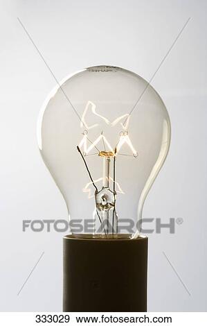 Stock Photo - Light bulb filament glowing. Fotosearch