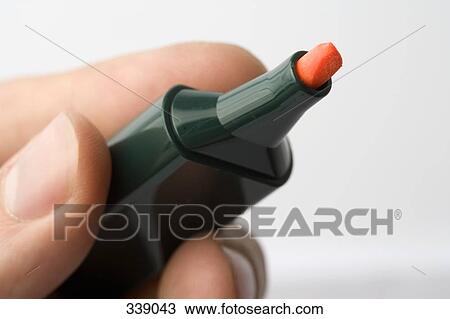 Stock Image - Hand holding highlighter pen. Fotosearch