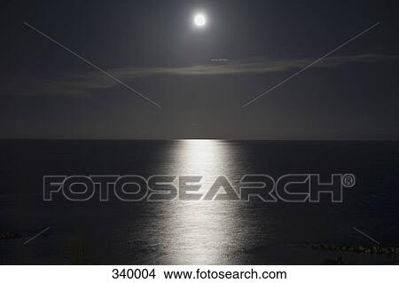 Full moon reflecting on water at night View Large Photo Image Picture - Full moon reflecting on water at night. Fotosearch