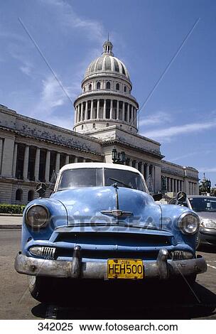 Stock Photography - Vintage car parked in front of El Capitolio, Havana, Cuba. Fotosearch