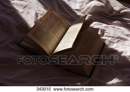 Open book on bed View Large Photo Image Stock Image - Open book on bed. Fotosearch