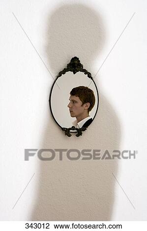 Reflection of young man in ornate mirror on wall View Large Photo Image Stock Image - Reflection of young man in ornate mirror on wall. Fotosearch