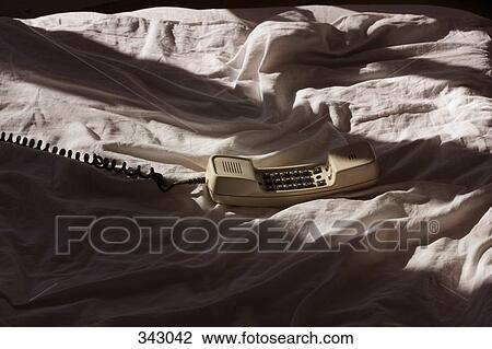 Telephone receiver off the hook on a bed View Large Photo Image Stock Image - Telephone receiver off the hook on a bed. Fotosearch