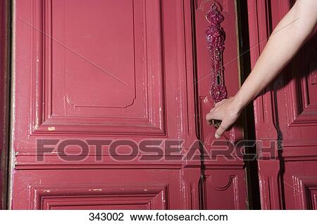 Woman closing pink door of apartment View Large Photo Image Stock Image - Woman closing pink door of apartment. Fotosearch