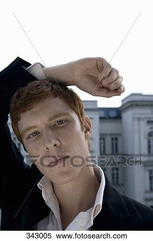 Young man resting arm on head View Large Photo Image Stock Photography - Young man resting arm on head. Fotosearch
