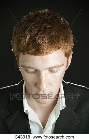 Young man with head down View Large Photo Image Stock Photo - Young man with head down. Fotosearch